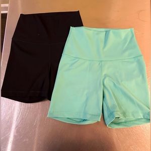two pairs of biker shorts. black worn once, green never worn.